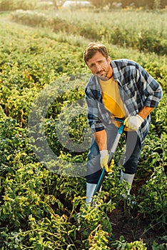 Rancher in shirt, gloves and rubber