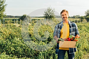 Rancher in shirt holding box with