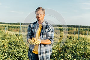 Rancher in shirt looking at camera