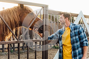 Rancher in shirt touching head of