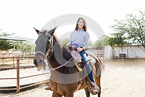 Rancher Smiling While Riding Brown Horse