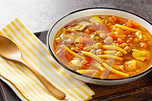 Rancho canario a typical Canary Islands dish with chickpeas and noodles closeup on the plate. Horizontal photo