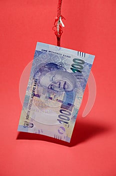 Rand note hanging on a tarnished rope