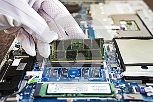 Random access memory for replacement to laptop computer. RAM module DDR in hand on the background of a modern notebook-transformer