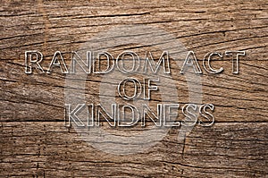 Random Act of Kindness written on wooden background