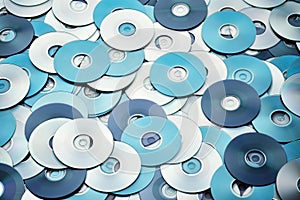 Random arrangement of silver blue grey DVD and CD data storage disks