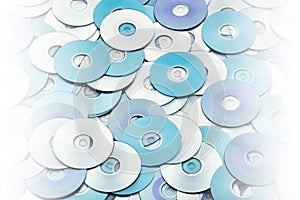 Random arrangement of silver blue grey DVD and CD data storage disks