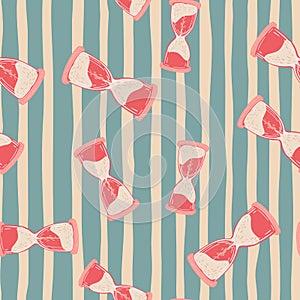 Random bright pink hourglass shapes seamless doodle pattern. Blue and pink striped background
