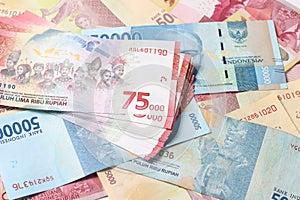 Random Layout Photo Rupiah Paper Money, 10000, 50000, 100000 and 75000 at White Background