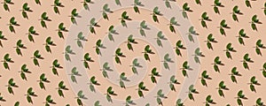 Random pieces of fresh mint in a pattern on the beige pastel background. Top view . Healthy greens,Continous pattern, flat lay,