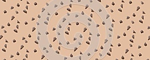 Random pieces of natural chocolate in a pattern on the beige pastel background. Top view of chocolate pieces. Healthy and tasty