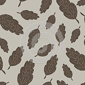 Random seamless pattern with doodle brown leaf ornament. Grey background. Autumn print