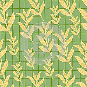 Random seamless pattern with pale yellow leaf branches ornament on green chequered background