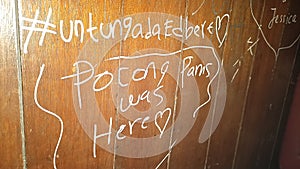 Random vandalism writing on a wooden wall