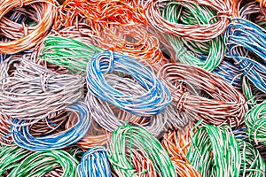 Random weaving of colored wire. Abstract colorful background of electrical cables. Multicolored wires entangled in many hanks