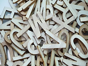 Random wooden alphabet letters top view on purple background