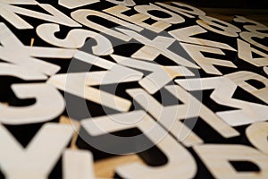 Random wooden block letters lying on wooden background