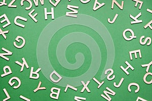 random wooden letter frame on green paper background