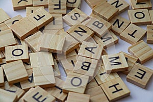 Random wooden letter stacks, wooden letter scrable toys, arrange wooden letters into words photo