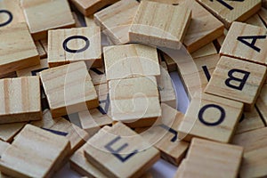 Random wooden letter stacks, wooden letter scrable toys, arrange wooden letters into words photo