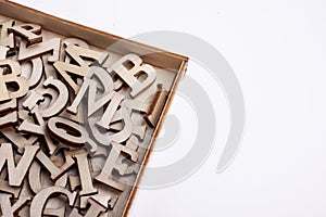 Random Wooden Letters in a box with white background