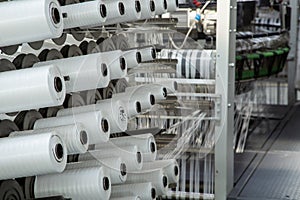 A range of equipment with spools of polypropylene threads.