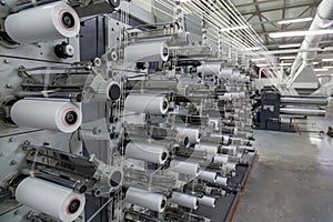 A range of equipment with spools of polypropylene threads.