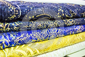 Range of fabrics in a pile with Eastern inspired patterns