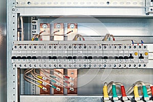 A range of modular electrical circuit breakers and differential switches in an electrical Cabinet.