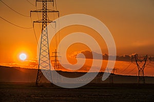 Power line towers at sunset