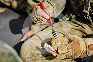 Rangers are heated food on the fire and eat in the forest