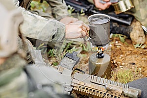 Rangers are heated food on the fire and eat in the forest