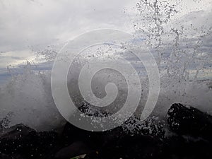 The ranging waves hit stone photo