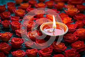 Rangoli elegance red rose floral design with a lit diya