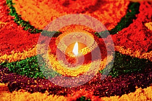 Rangoli with glowing diya