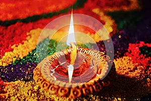 Rangoli with glowing diya