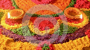 Rangoli with glowing diyas