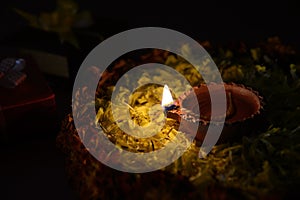 Rangoli of Marigold flowers with Diwali Diya and Gift boxes