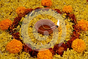 Rangoli of Marigold flowers with Diwali Diya and gift boxes for festival