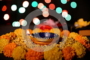 Rangoli of Marigold flowers with Diwali Diya and gift boxes for festival