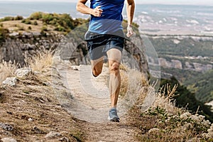 rangy male runner run on mountain trail