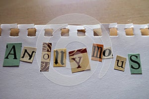 Ransom note style collage saying Anonymous on a sheet of white paper torn out of a notebook