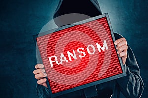 Ransomware computer virus concept, hacker with monitor photo