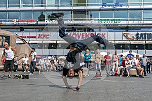 A rap dancer performing in a park.