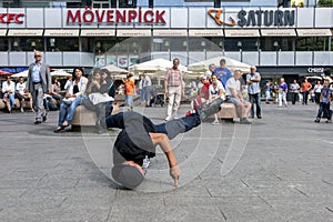 A rap dancer performing in a park.