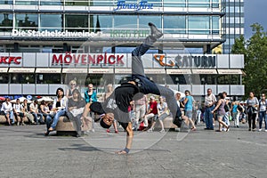 A rap dancer performing in a park.