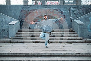 Rap performer posing on the steps, street dancing