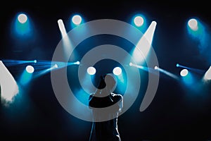 Rap singer with microphone on stage in music hall