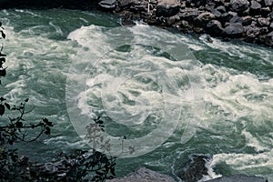 Rapid flow of a mountain river.  Clear water surface