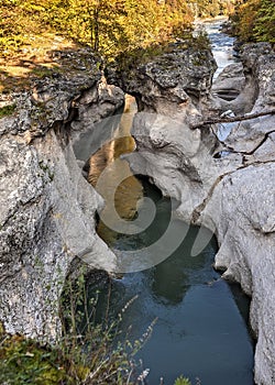 Rapid mountain river washed in lime line with bizarre twists.